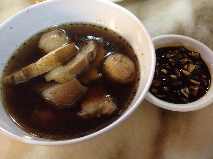 A small bowl of Bah kut teh with sauce and garlic